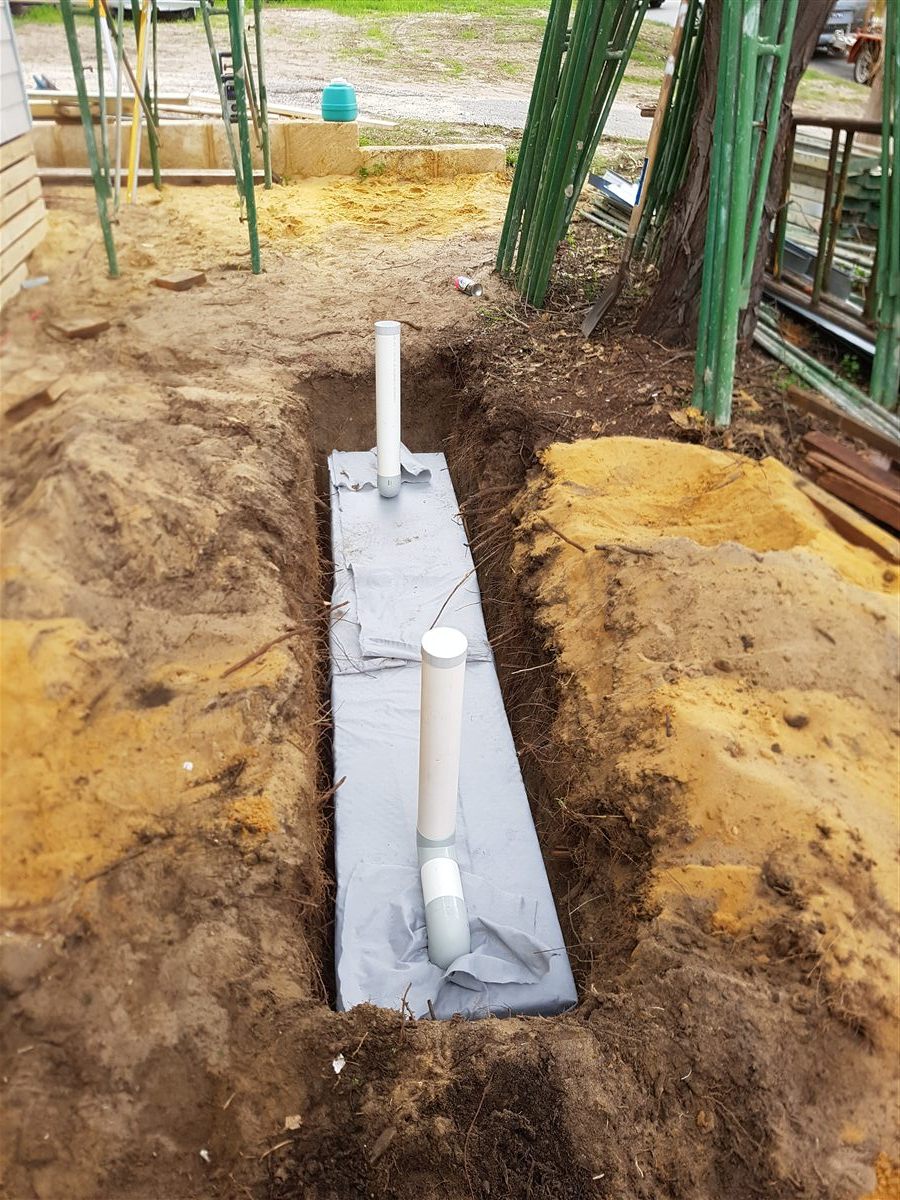 Polypropylene soakwell installation trench prepared for a residential stormwater system